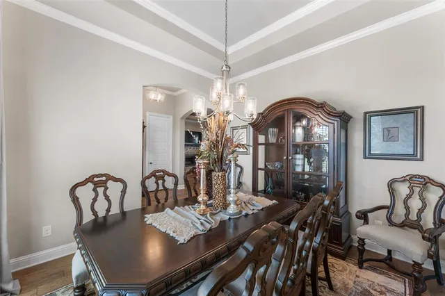 a view of a dining room with furniture and chandelier