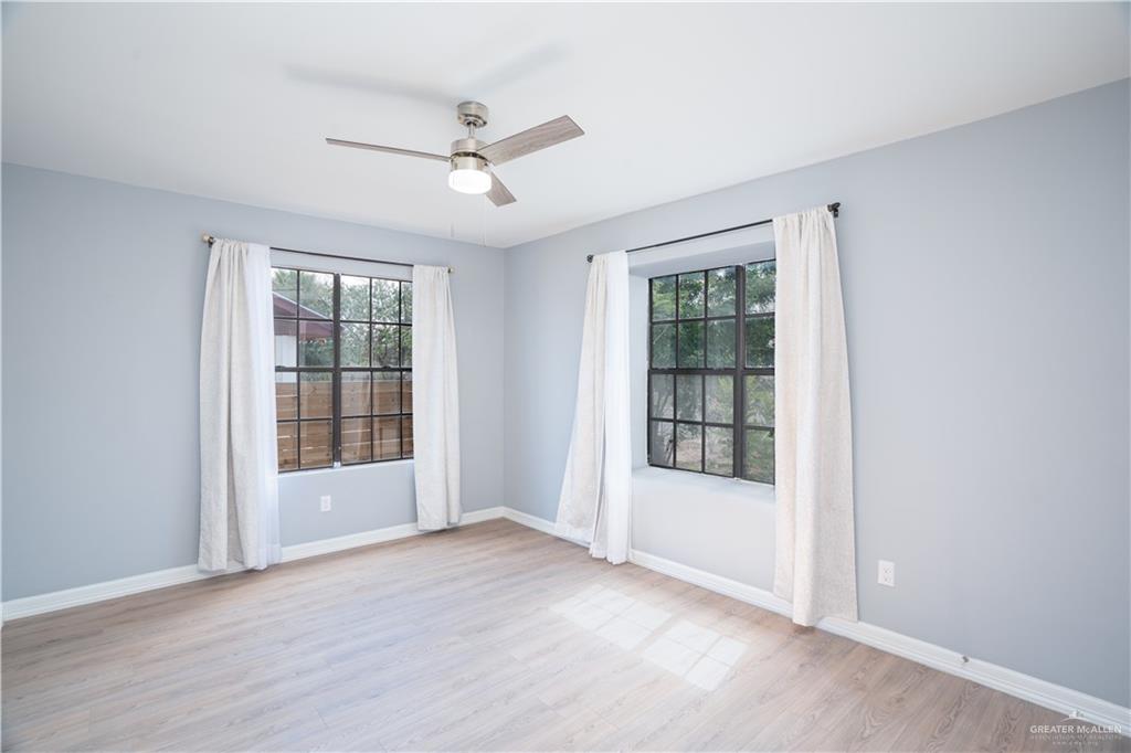 212 North Street Mission, TX 78572 - Photo 13 of 26 a view of an empty room with a window and wooden floor