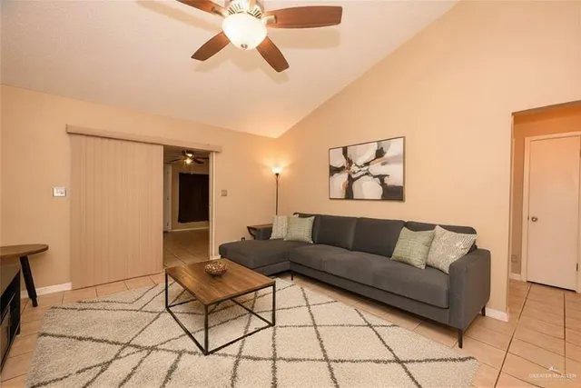 a living room with a couch and a dining table
