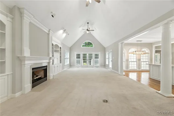 a view of an empty room with a fireplace and a window