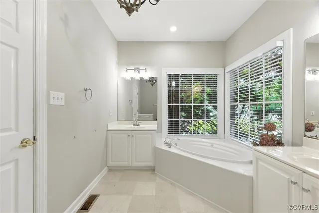a spacious bathroom with sink shower and bathtub