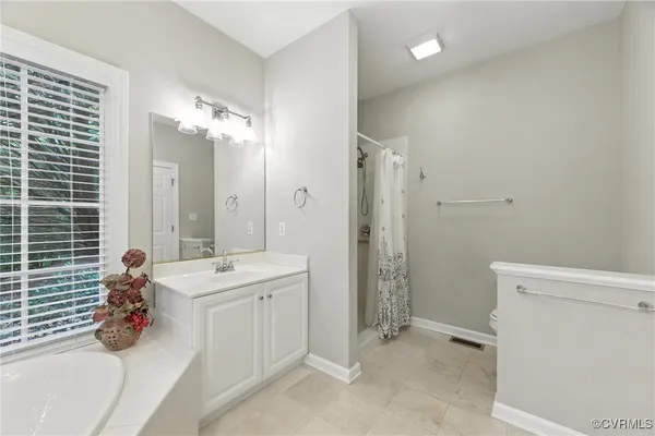a bathroom with a double vanity sink mirror and shower