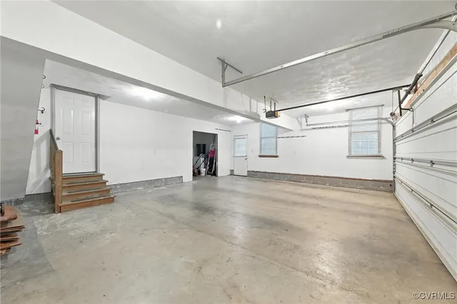 an aerial view of a house with a yard and lake view