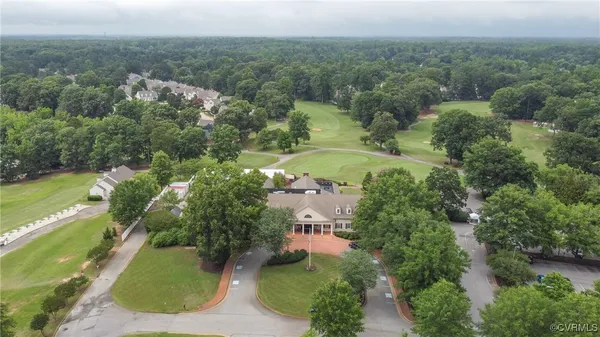 an aerial view of a house with a yard and lake view