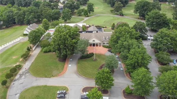 an aerial view of house with yard and mountain view in back