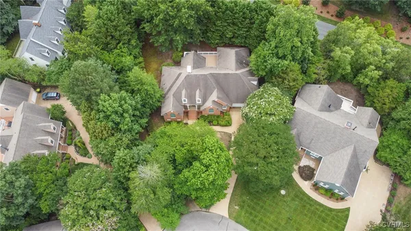 an aerial view of a house with garden space and street view