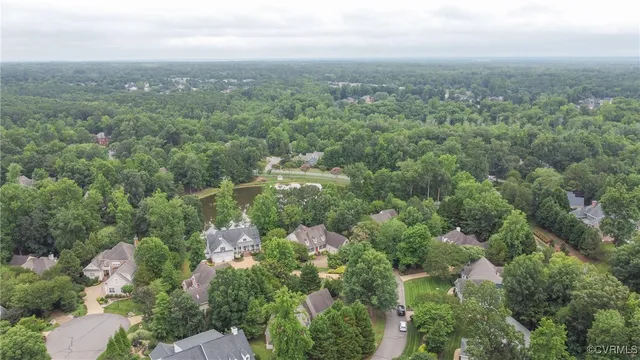 an aerial view of house with yard and mountain view in back