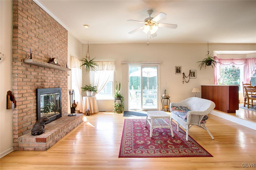 90 Morvale Road Easton, PA 18042 - Photo 7 of 38 a living room with furniture a fireplace and a table with wooden floor