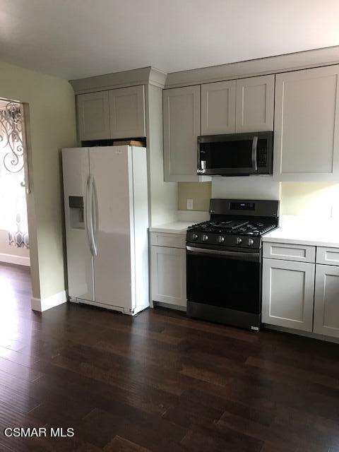 930 Alta Vista Road Simi Valley, CA 93063 - Photo 25 of 39 a kitchen with wooden cabinets and a stove top oven