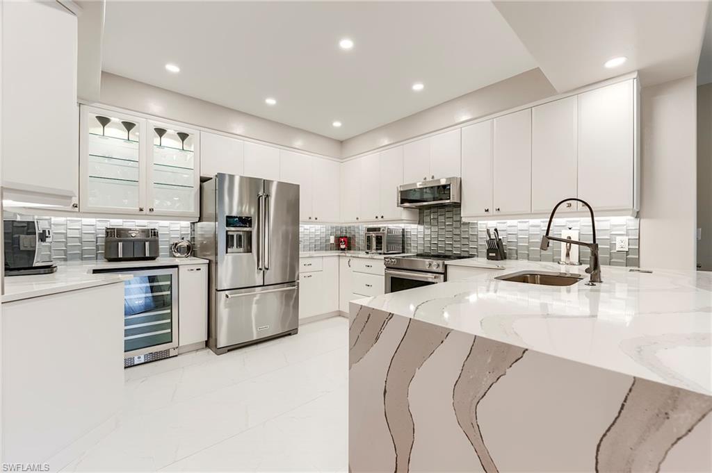 a kitchen with refrigerator and cabinets