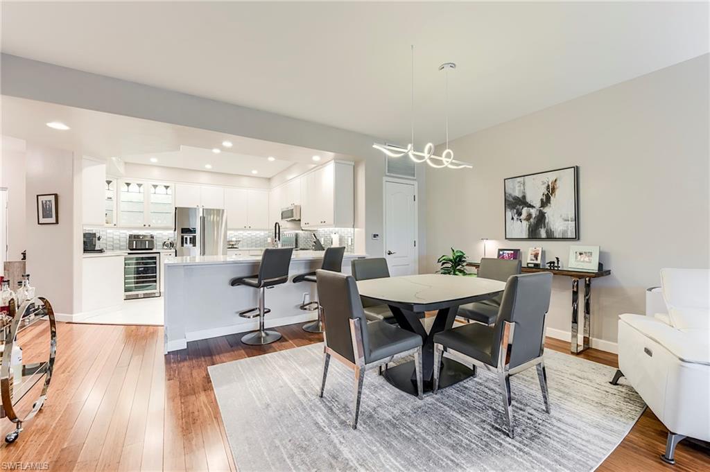 23815 Clear Spring Court, Unit 2105 Estero, FL 34135 - Photo 12 of 37 a view of a dining room with furniture and wooden floor