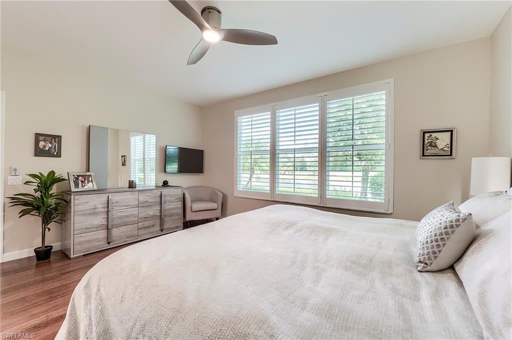 23815 Clear Spring Court, Unit 2105 Estero, FL 34135 - Photo 15 of 37 a bedroom with a large bed and a flat screen tv