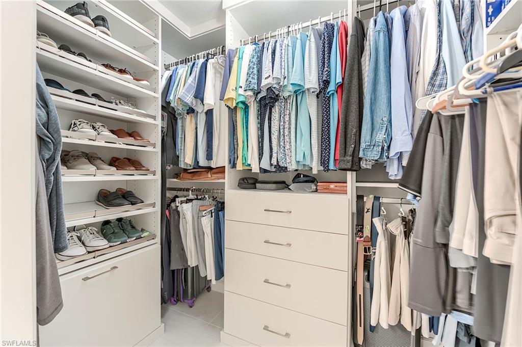 23815 Clear Spring Court, Unit 2105 Estero, FL 34135 - Photo 17 of 37 a view of walk in closet with clothes and shoes