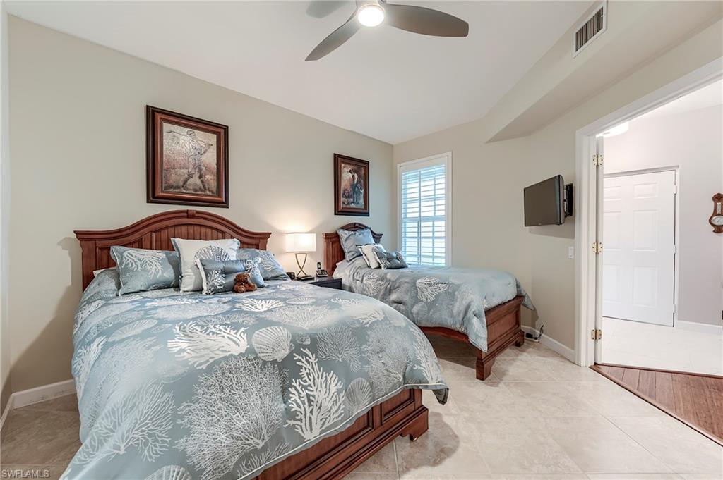 23815 Clear Spring Court, Unit 2105 Estero, FL 34135 - Photo 18 of 37 a bedroom with two beds and a window