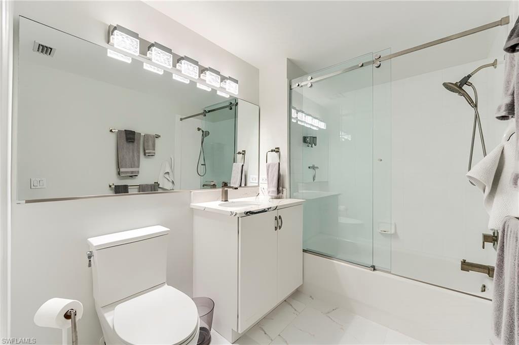 23815 Clear Spring Court, Unit 2105 Estero, FL 34135 - Photo 20 of 37 a bathroom with a toilet a sink and a mirror