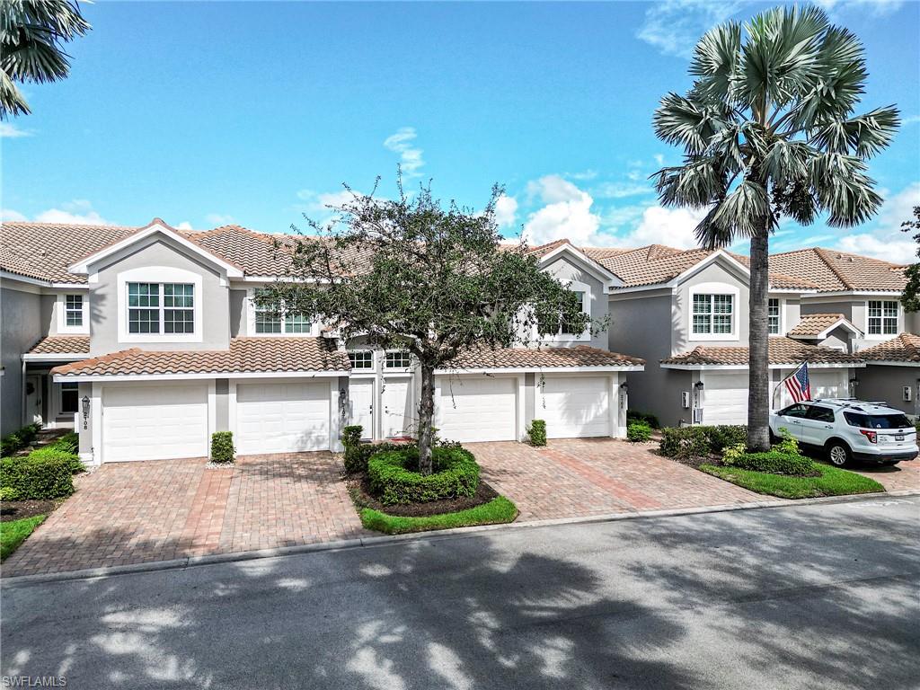 23815 Clear Spring Court, Unit 2105 Estero, FL 34135 - Photo 29 of 37 a front view of a house with garden