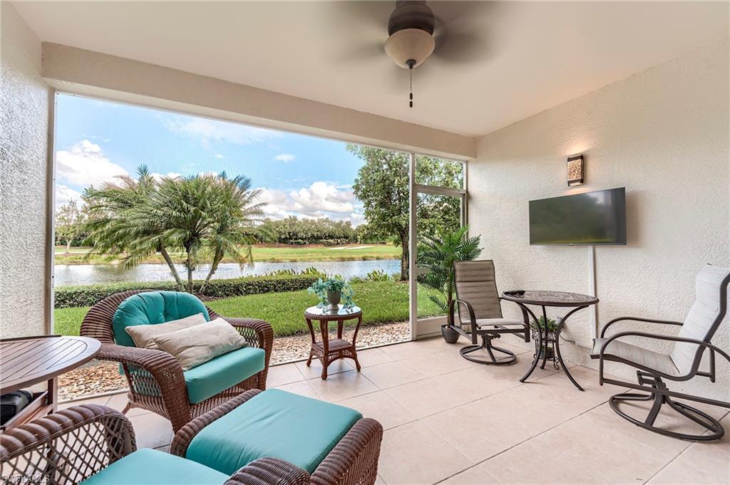 23815 Clear Spring Court, Unit 2105 Estero, FL 34135 - Photo 3 of 37 a living room with patio furniture and a flat screen tv