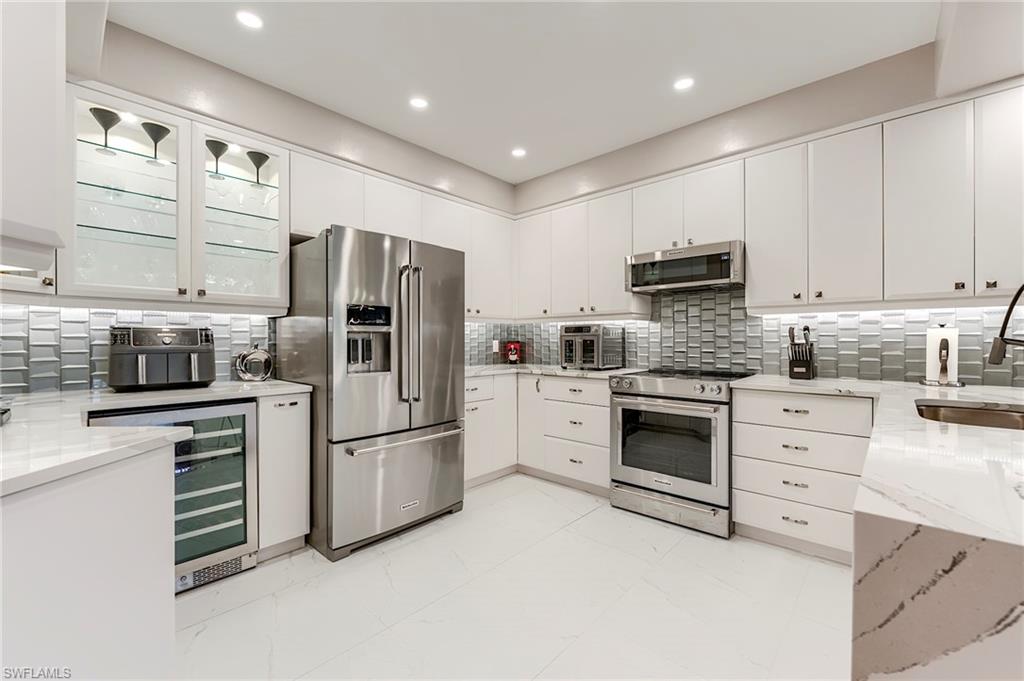 23815 Clear Spring Court, Unit 2105 Estero, FL 34135 - Photo 4 of 37 a kitchen with stainless steel appliances cabinets and a counter top space