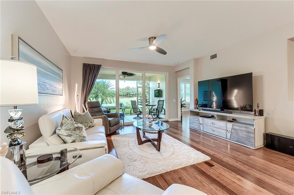 23815 Clear Spring Court, Unit 2105 Estero, FL 34135 - Photo 9 of 37 a living room with furniture and a flat screen tv