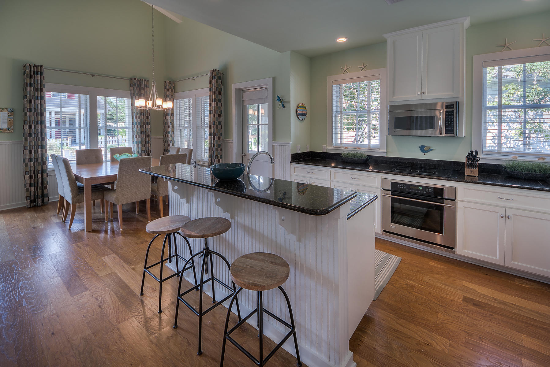 295 Salt Lane Inlet Beach, FL 32461 - Photo 2 of 26 a kitchen with stainless steel appliances granite countertop a stove a sink dishwasher a dining table and chairs with wooden floor