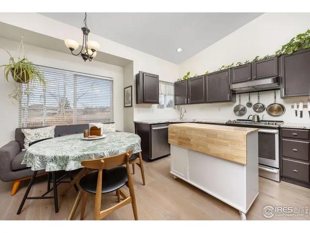 a kitchen with a table chairs and refrigerator