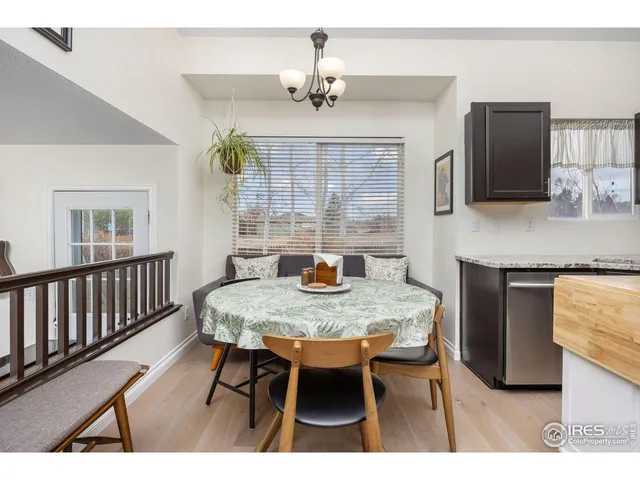 a view of a workspace with furniture and wooden floor