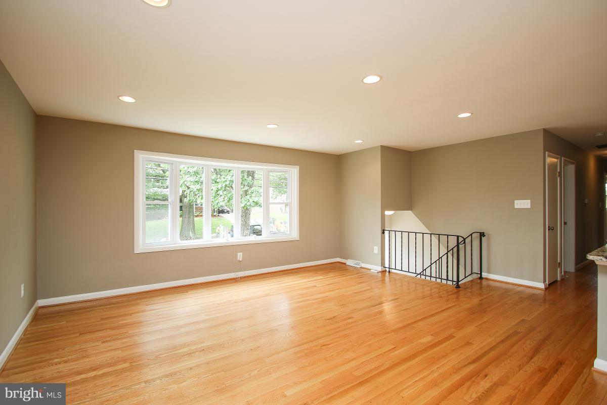 6903 Presley Road Lanham, MD 20706 - Photo 5 of 28 a view of an empty room with wooden floor and a window