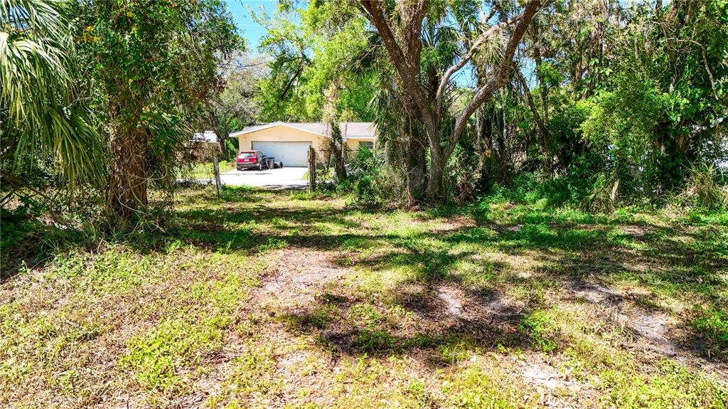 9240 Creston Avenue New Port Richey, FL 34654 - Photo 27 of 39 a backyard of a house with a garden and plants