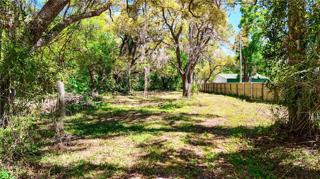 9240 Creston Avenue New Port Richey, FL 34654 - Photo 34 of 39 a swimming pool with wooden fence