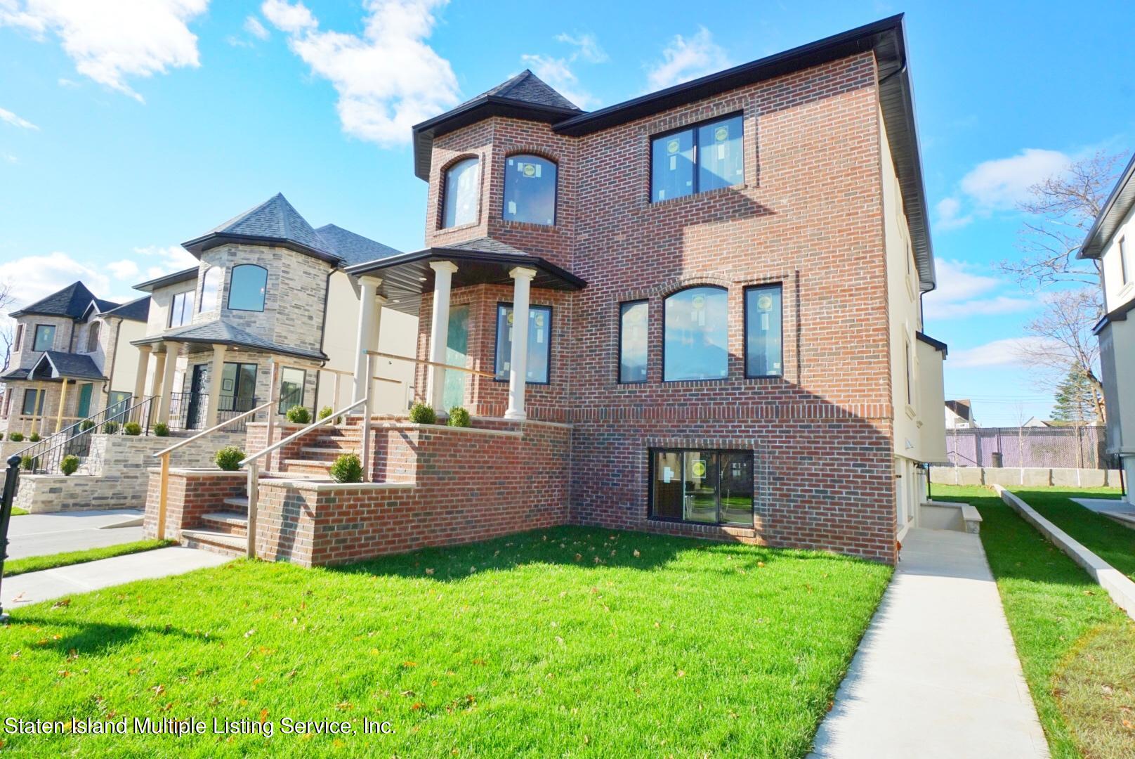 45 Torrice Loop Staten Island, NY 10309 - Photo 2 of 10 a front view of a house with a yard
