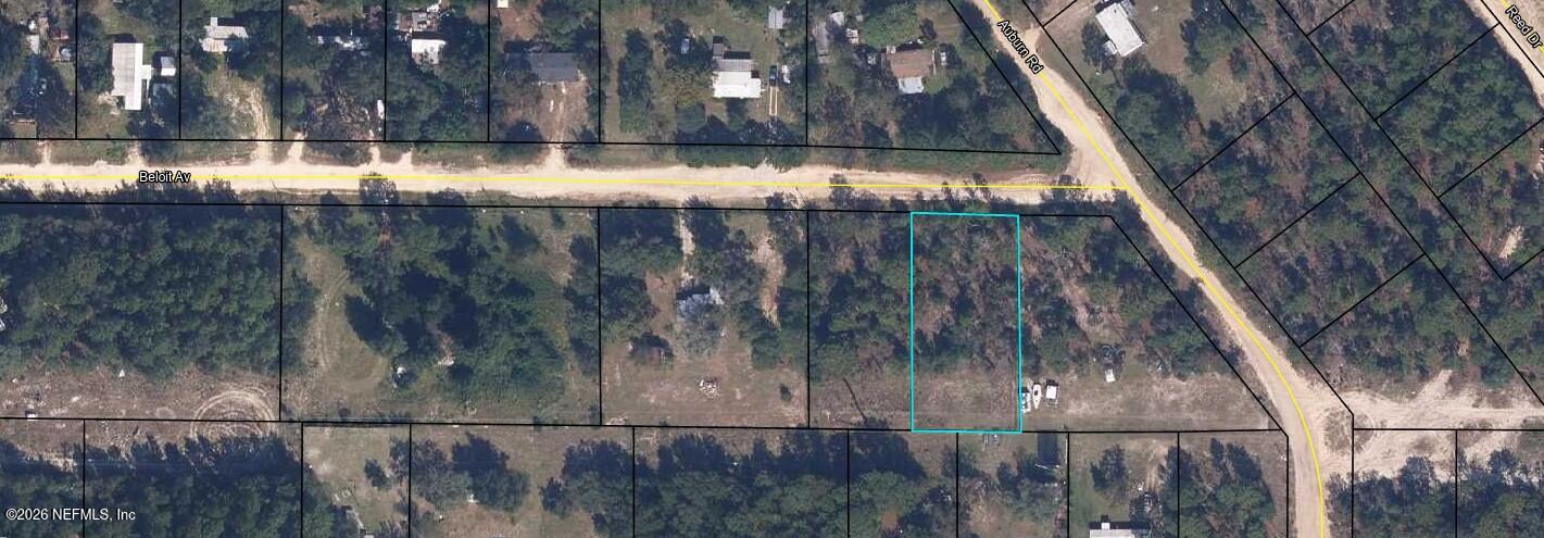 a view of backyard with wooden fence