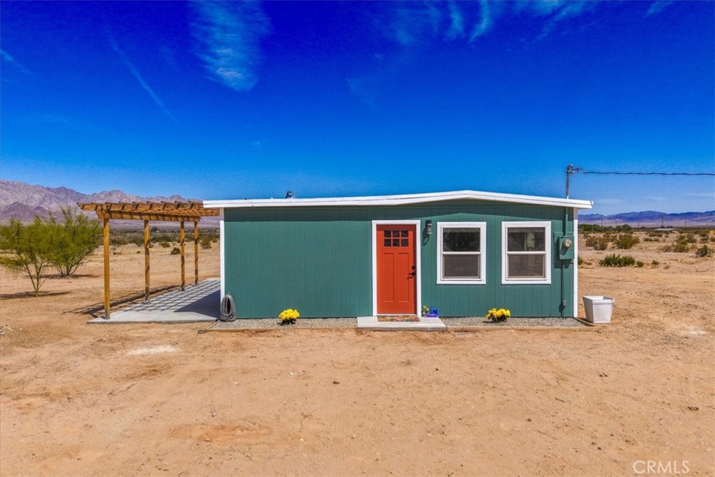 84320 McCombie Road Twentynine Palms, CA 92277 - Photo 1 of 57 a front view of a house with a yard