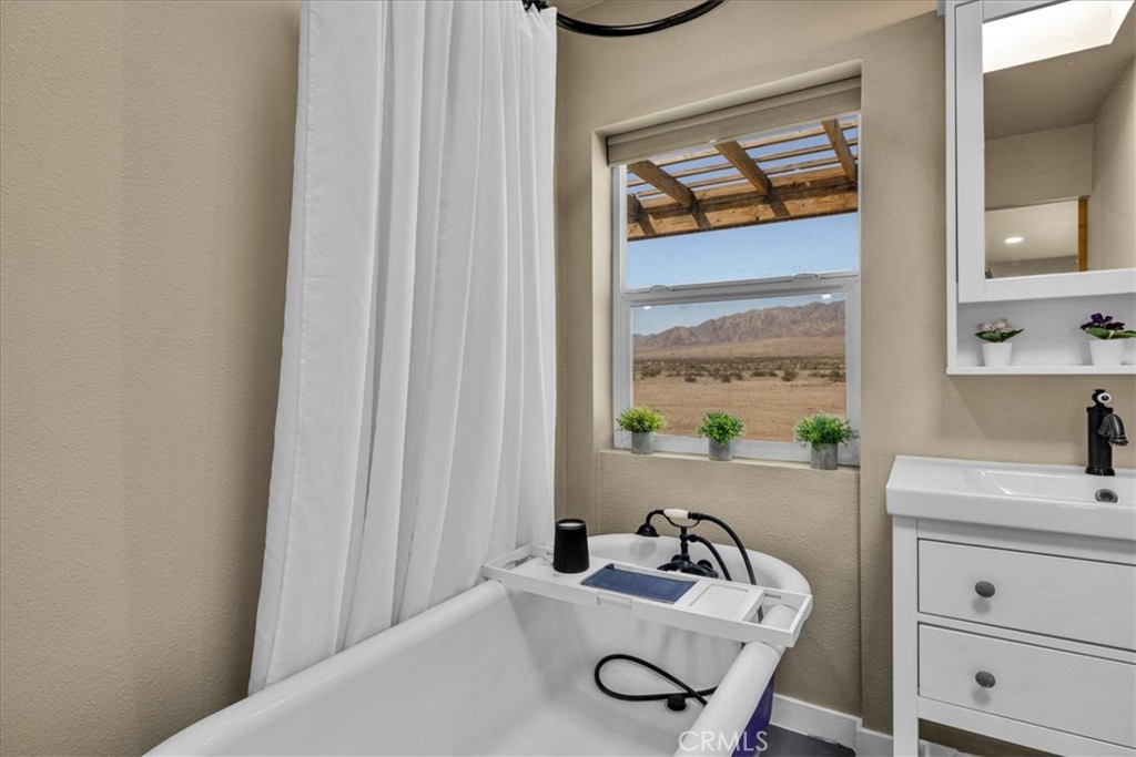 84320 McCombie Road Twentynine Palms, CA 92277 - Photo 22 of 57 a bathroom with a sink and a window