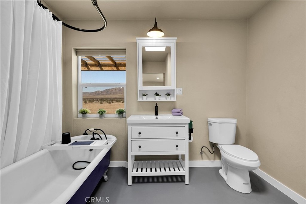 84320 McCombie Road Twentynine Palms, CA 92277 - Photo 23 of 57 a bathroom with a sink a toilet and a mirror