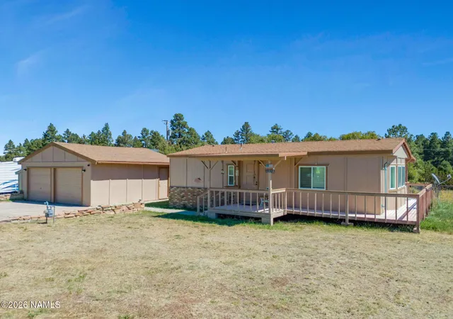 a front view of a house with a yard and potted plants