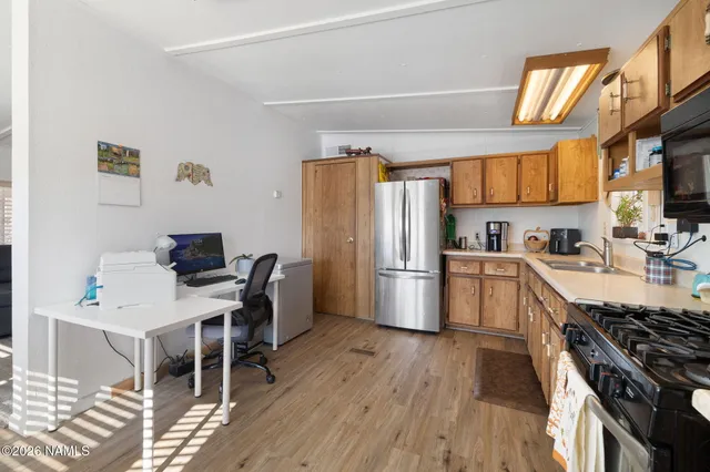 a kitchen with stainless steel appliances a stove a refrigerator and a sink