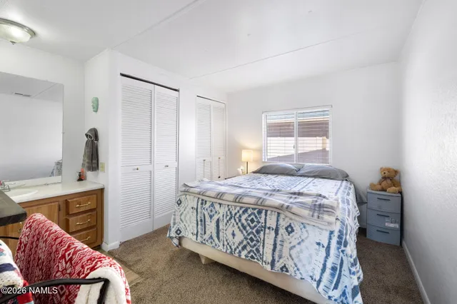 a bedroom with a bed and a chair