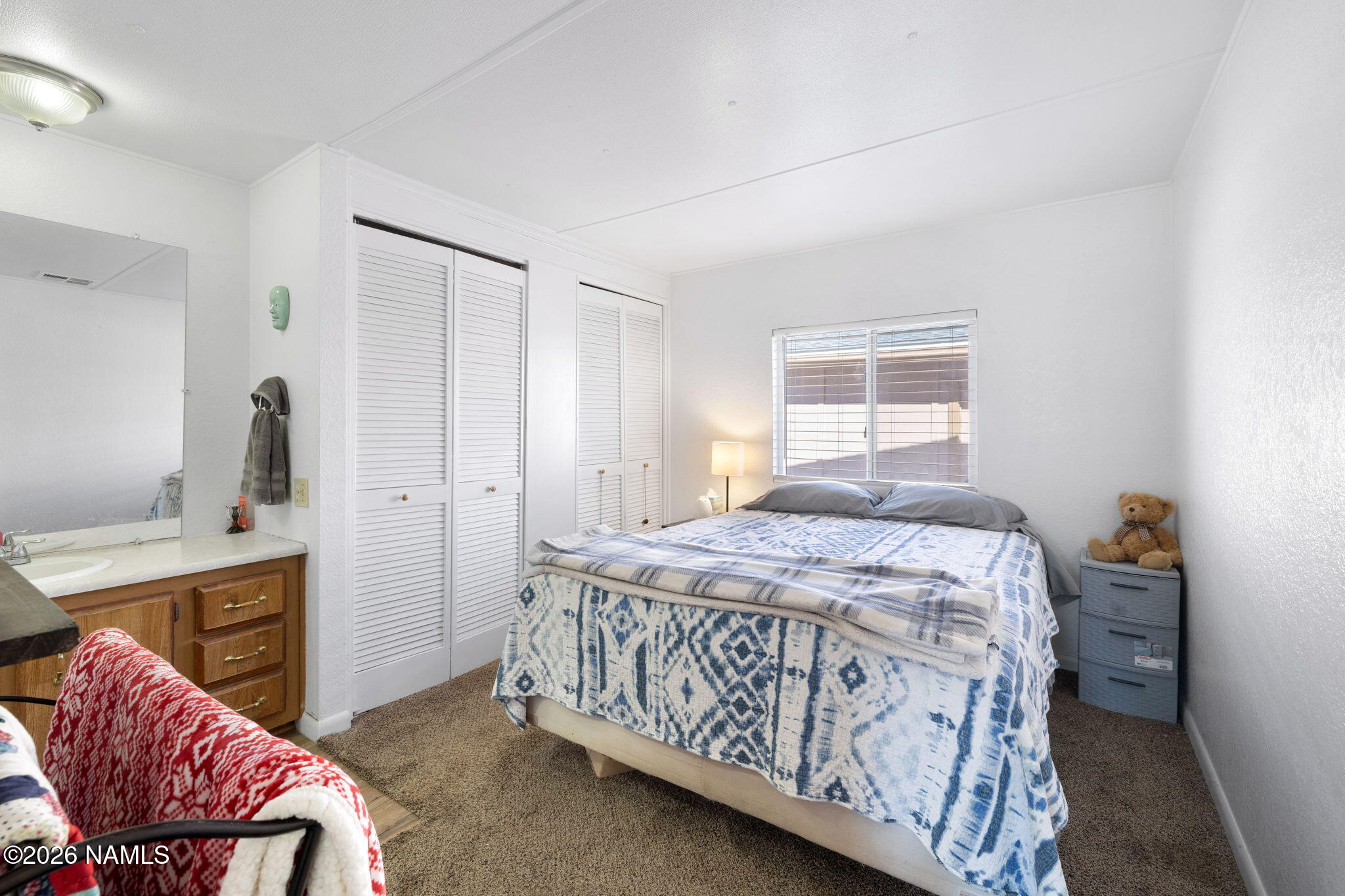 1050 North Arpt Road Williams, AZ 86046 - Photo 17 of 29 a bedroom with a bed and a chair