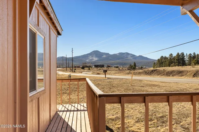 a view of balcony with furniture and a yard