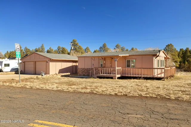 a view of a house with wooden fence
