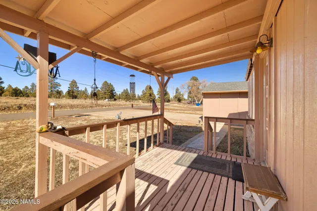 a view of a balcony with chairs and wooden floor