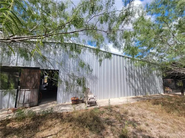 a backyard of a house with table and chairs