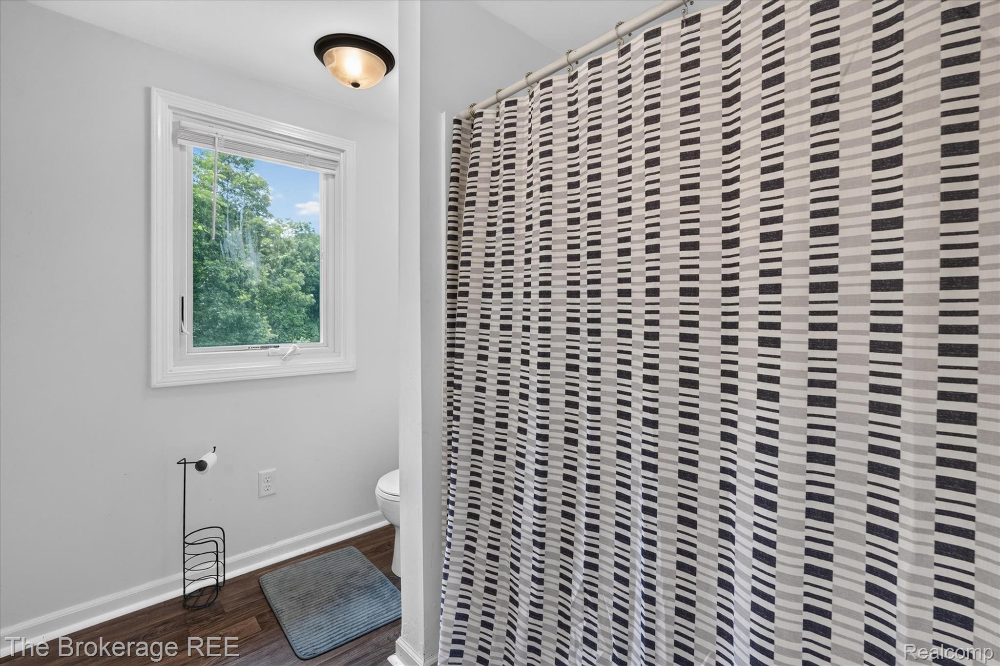 13269 North Genesee Road Clio, MI 48420 - Photo 38 of 67 Bathroom featuring a white-framed window, wood-finish flooring, and light gray walls