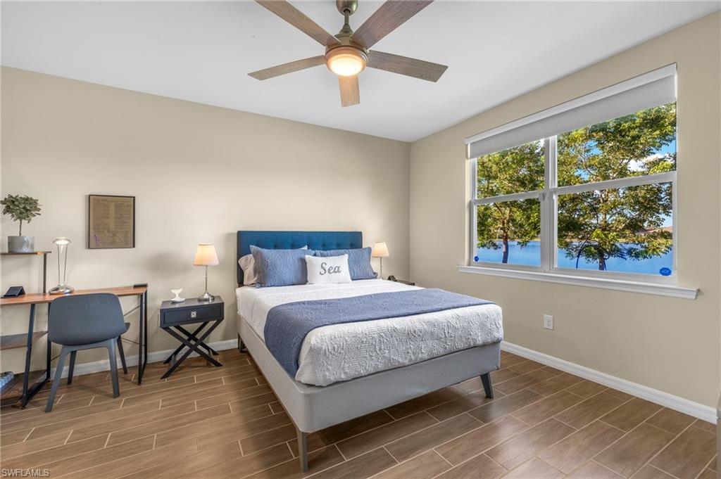 14644 Edgewater Circle Naples, FL 34114 - Photo 13 of 39 a bedroom with a bed and a table