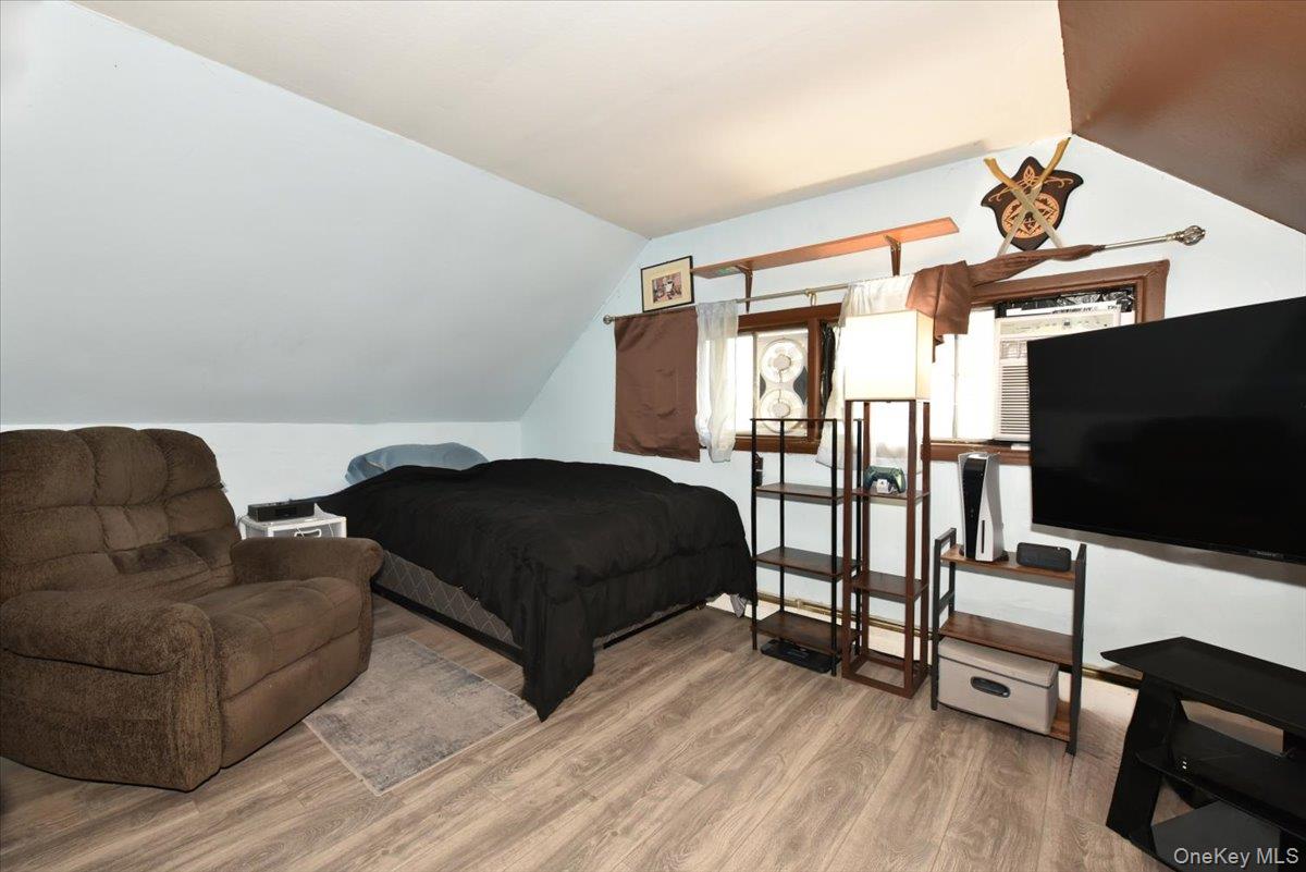 307 Blacksmith Road Levittown, NY 11756 - Photo 21 of 27 a bedroom with a bed and a flat screen tv