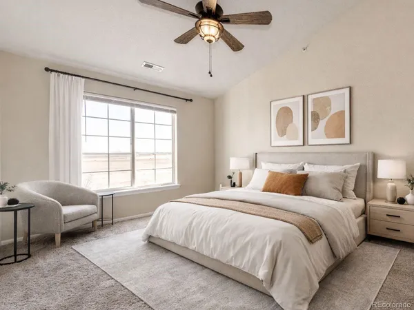 a bedroom with a bed couches and window