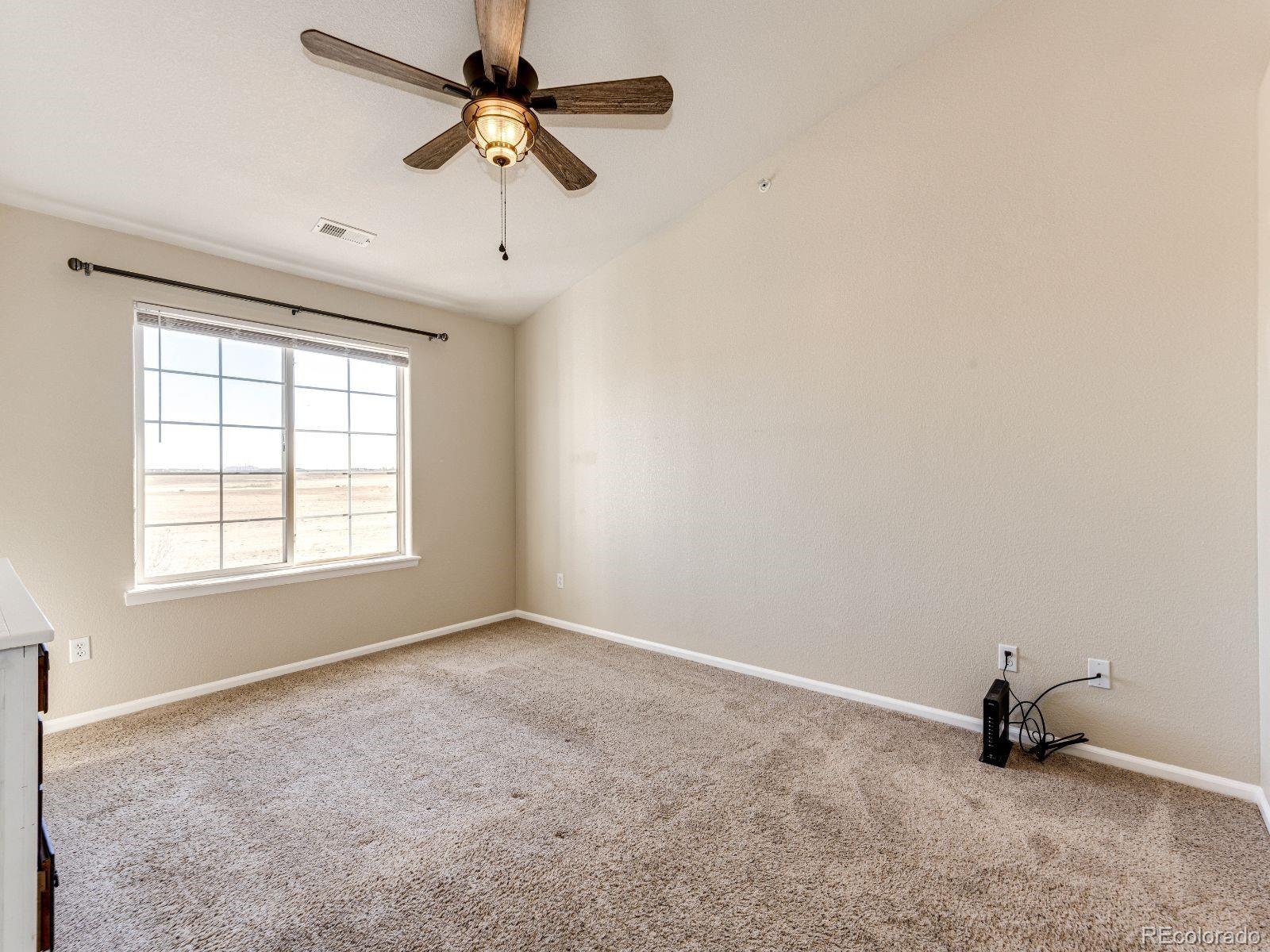 5255 Memphis Street, Unit 122 Denver, CO 80239 - Photo 16 of 26 an empty room with a window and a fan