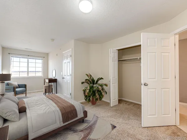 a bedroom with a bed and a couch