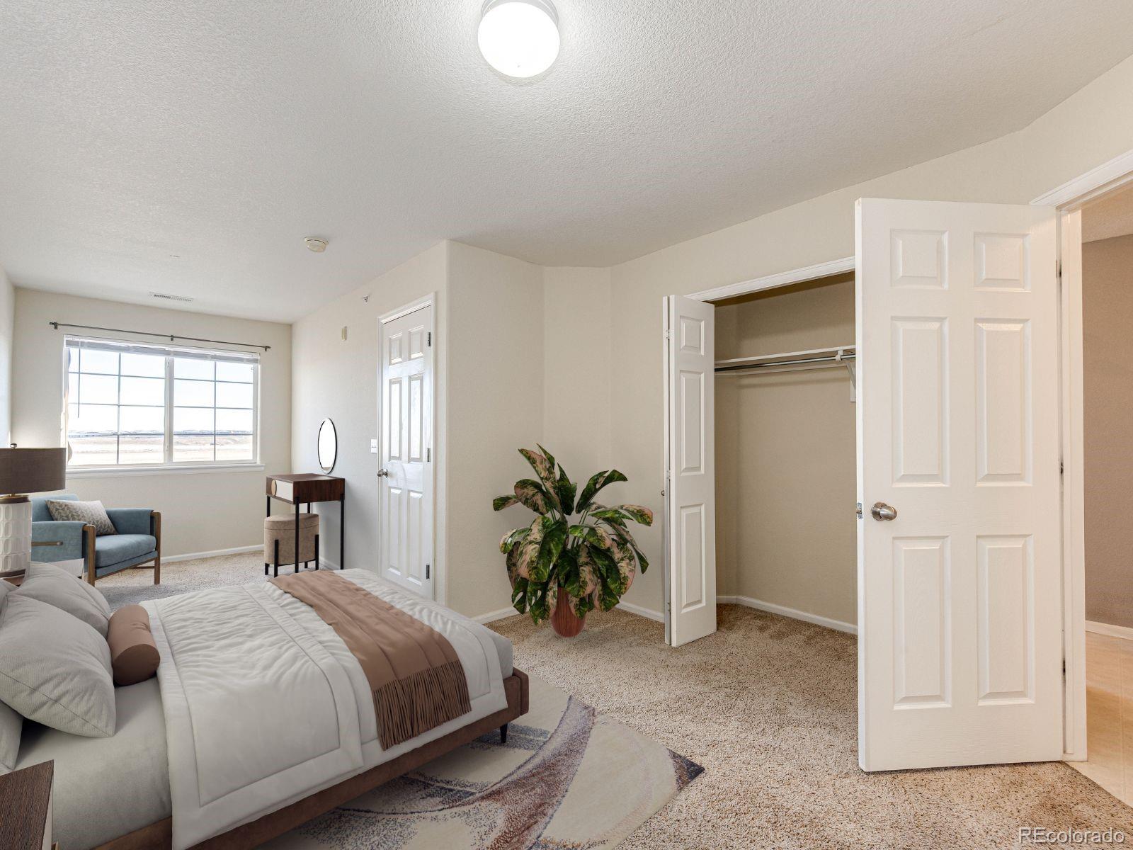 5255 Memphis Street, Unit 122 Denver, CO 80239 - Photo 20 of 26 a bedroom with a bed and a couch
