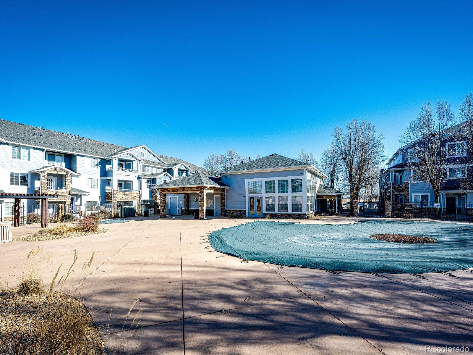5255 Memphis Street, Unit 122 Denver, CO 80239 - Photo 24 of 26 a front view of building with yard and trees